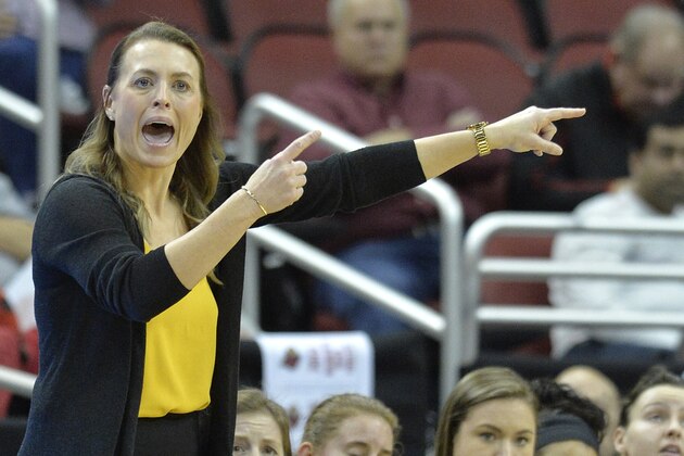 Northern Kentucky head coach Camryn Whitaker signals a play in to her team during the first half of an NCAA college basketball game against Louisville in Louisville, Ky., Saturday, Dec. 15, 2018. (AP Photo/Timothy D. Easley)
