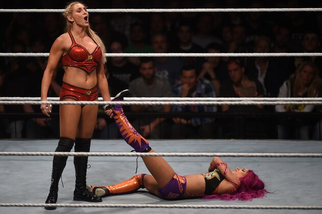 WWE wrestling stars Sasha Bank (R) and Charlotte Flair (L) fight during a WWE (World Wrestling Entertainment) women's fight at the Olympic hall in Munich, southern Germany, on November 3, 2016.  / AFP / CHRISTOF STACHE        (Photo credit should read CHRISTOF STACHE/AFP/Getty Images)