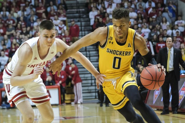 Wichita State guard Dexter Dennis, right, drives around Indiana guard Zach McRoberts in the first half of an NCAA college basketball game in the third round of the NIT tournament in Bloomington, Ind., Tuesday, March 26, 2019. (AP Photo/AJ Mast)