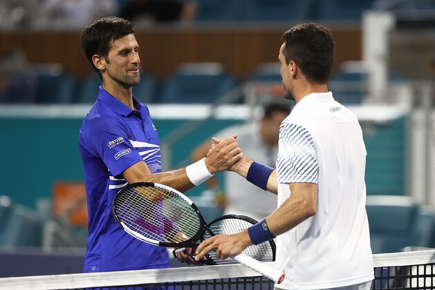 MIAMI GARDENS, FLORIDA - MARCH 26:  Roberto Bautista Agut of Spain is congratulated by Novak Djokovic of Serbia after their match during the Miami Open tennis on March 26, 2019 in Miami Gardens, Florida. (Photo by Julian Finney/Getty Images)