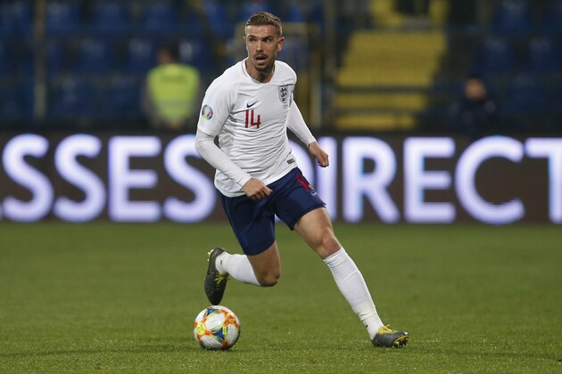 England's Jordan Henderson runs with the ball during the Euro 2020 group A qualifying soccer match between Montenegro and England at the City Stadium in Podgorica, Montenegro, Monday, March 25, 2019. (AP Photo/Darko Vojinovic)