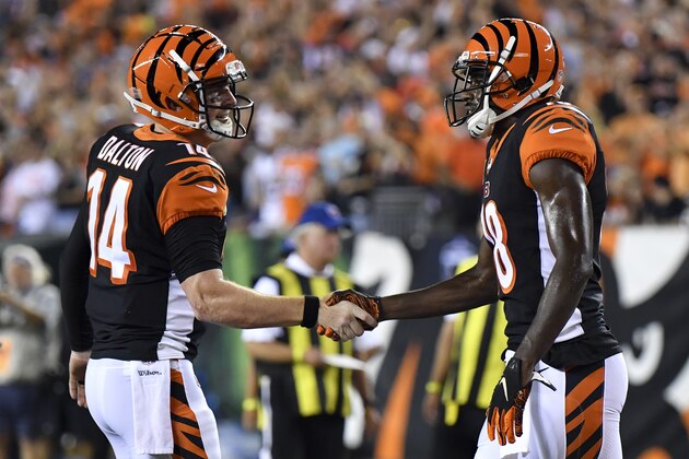Cincinnati Bengals wide receiver A.J. Green, right, celebrates with quarterback Andy Dalton (14) after scoring a touchdown in the first half of an NFL football game, Thursday, Sept. 13, 2018, in Cincinnati. (AP Photo/Bryan Woolston)