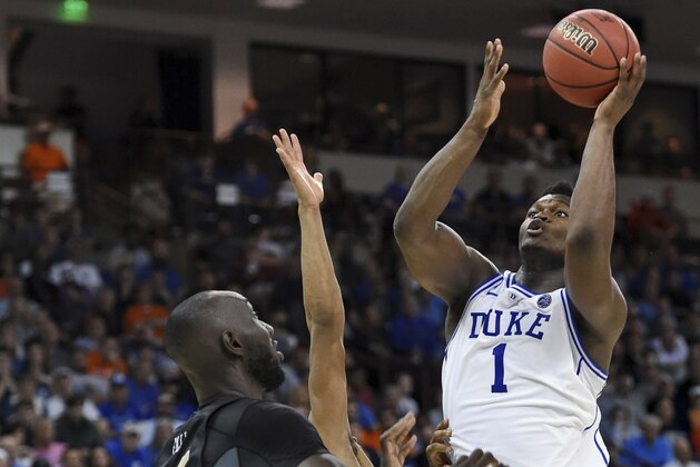 Duke's Zion Williamson shoots over Central Florida's Tacko Fall during the second half of a second-round men's college basketball game in the NCAA Tournament in Columbia, S.C. Sunday, March 24, 2019. (AP Photo/Richard Shiro)