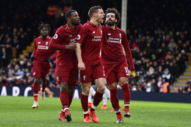 Liverpool's English midfielder James Milner (C) celebrates scoring the team's second goal during the English Premier League football match between Fulham and Liverpool at Craven Cottage in London on March 17, 2019. (Photo by Glyn KIRK / AFP) / RESTRICTED TO EDITORIAL USE. No use with unauthorized audio, video, data, fixture lists, club/league logos or 'live' services. Online in-match use limited to 120 images. An additional 40 images may be used in extra time. No video emulation. Social media in-match use limited to 120 images. An additional 40 images may be used in extra time. No use in betting publications, games or single club/league/player publications. /         (Photo credit should read GLYN KIRK/AFP/Getty Images)