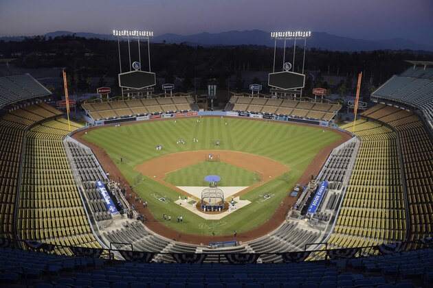 The Los Angeles Dodgers practice in an empty stadium for Game 1 of the baseball team's NLCS against the Milwaukee Brewers, Wednesday, Oct. 10, 2018, in Los Angeles. (AP Photo/Mark J. Terrill)