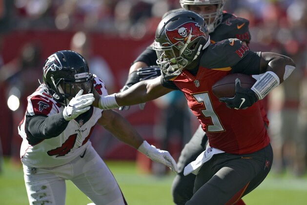 Tampa Bay Buccaneers quarterback Jameis Winston (3) stiff arms Atlanta Falcons defensive end Vic Beasley (44) on a run during the first half of an NFL football game Sunday, Dec. 30, 2018, in Tampa, Fla. (AP Photo/Jason Behnken)