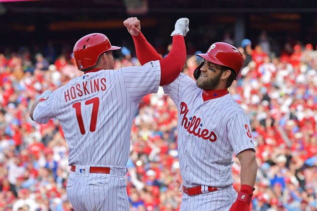 PHILADELPHIA, PA - MARCH 28: Rhys Hoskins #17 and Bryce Harper #3 of the Philadelphia Phillies celebrate Hoskins grand slam in the seventh inning against the Atlanta Braves on Opening Day at Citizens Bank Park on March 28, 2019 in Philadelphia, Pennsylvania. (Photo by Drew Hallowell/Getty Images)