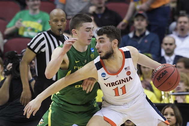 Virginia's Ty Jerome (11) is defended by Oregon's Payton Pritchard during the first half of a men's NCAA Tournament college basketball South Regional semifinal game, Thursday, March 28, 2019, in Louisville, Ky. (AP Photo/Timothy D. Easley)