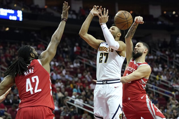 Denver Nuggets' Jamal Murray (27) has his shot blocked by Houston Rockets' Austin Rivers, right, as Nene Hilario (42) defends during the first half of an NBA basketball game Thursday, March 28, 2019, in Houston. (AP Photo/David J. Phillip)