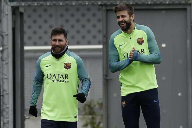 FC Barcelona's Lionel Messi, left, and Gerard Pique attend a training session at the Sports Center FC Barcelona Joan Gamper in Sant Joan Despi, Spain, Saturday, Jan. 21, 2017. Eibar will play against FC Barcelona in a Spanish La Liga on Sunday. (AP Photo/Manu Fernandez)