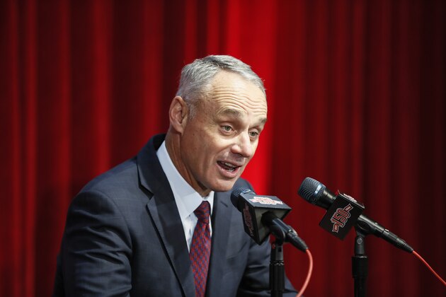 Major League Baseball Commissioner Rob Manfred speaks to reporters before an opening day baseball game between the Cincinnati Reds and the Pittsburgh Pirates, Thursday, March 28, 2019, in Cincinnati. (AP Photo/John Minchillo)