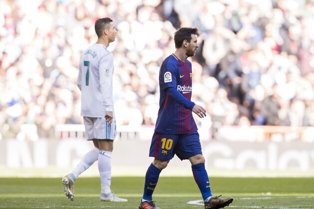 MADRID, SPAIN - DECEMBER 23: Lionel Andres Messi (R) of FC Barcelona and Cristiano Ronaldo of Real Madrid look on during the La Liga 2017-18 match between Real Madrid and FC Barcelona at Santiago Bernabeu Stadium on December 23 2017 in Madrid, Spain. (Photo by Power Sport Images/Getty Images)