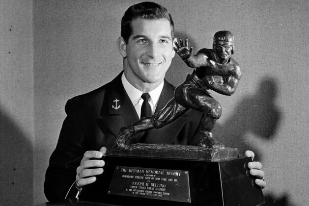 All-America back Joe Bellino of the Navy is shown with the Heisman Trophy at a luncheon in New York, Dec. 8, 1960.  (AP Photo/Harry Harris)