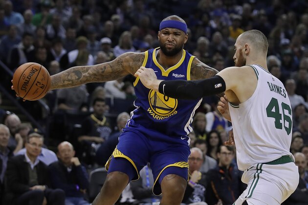 Golden State Warriors' DeMarcus Cousins, left, drives the ball against Boston Celtics' Aron Baynes (46) during the first half of an NBA basketball game Tuesday, March 5, 2019, in Oakland, Calif. (AP Photo/Ben Margot)