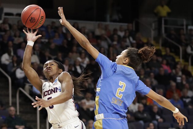 UCLA guard Ahlana Smith (2) defends against Connecticut guard Crystal Dangerfield (5) during the first half of a regional semifinal game in the NCAA women's college basketball tournament, Friday, March 29, 2019, in Albany, N.Y. (AP Photo/Kathy Willens)