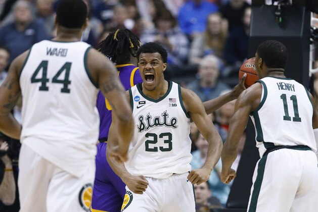 Michigan State forward Xavier Tillman (23) turns to looks at teammates Nick Ward (44) and Aaron Henry (11) after scoring against LSU during the first half of an East Regional semifinal in the NCAA men's college basketball tournament in Washington, Friday, March 29, 2019. (AP Photo/Patrick Semansky)