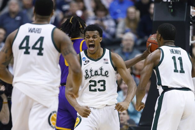 Michigan State forward Xavier Tillman (23) turns to looks at teammates Nick Ward (44) and Aaron Henry (11) after scoring against LSU during the first half of an East Regional semifinal in the NCAA men's college basketball tournament in Washington, Friday, March 29, 2019. (AP Photo/Patrick Semansky) Michigan State forward Xavier Tillman (23) turns to looks at teammates Nick Ward (44) and Aaron Henry (11) after scoring against LSU during the first half of an East Regional semifinal in the NCAA men's college basketball tournament in Washington, Friday, March 29, 2019. (AP Photo/Patrick Semansky)