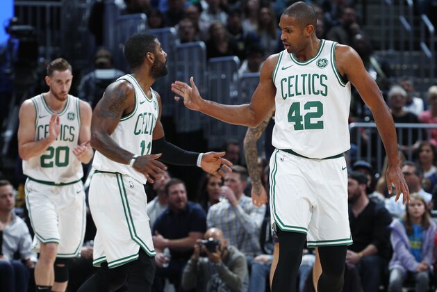 Boston Celtics guard Kyrie Irving, left, congratulates center Al Horford after his basket against the Denver Nuggets in the first half of an NBA basketball game Monday, Nov. 5, 2018, in Denver. (AP Photo/David Zalubowski)