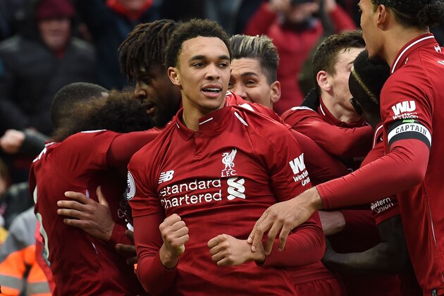 Liverpool's English defender Trent Alexander-Arnold (C) and teammates celebrate after a late own goal from Tottenham Hotspur's Belgian defender Toby Alderweireld (not pictured) during the English Premier League football match between Liverpool and Tottenham Hotspur at Anfield in Liverpool, north west England on January 31, 2019. (Photo by Paul ELLIS / AFP) / RESTRICTED TO EDITORIAL USE. No use with unauthorized audio, video, data, fixture lists, club/league logos or 'live' services. Online in-match use limited to 120 images. An additional 40 images may be used in extra time. No video emulation. Social media in-match use limited to 120 images. An additional 40 images may be used in extra time. No use in betting publications, games or single club/league/player publications. /         (Photo credit should read PAUL ELLIS/AFP/Getty Images)