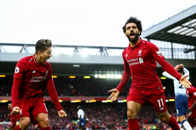 LIVERPOOL, ENGLAND - MARCH 31:  Mohamed Salah of Liverpool celebrates after Toby Alderweireld of Tottenham Hotspurscores an own goal to make it 2-1during the Premier League match between Liverpool FC and Tottenham Hotspur at Anfield on March 31, 2019 in Liverpool, United Kingdom. (Photo by Robbie Jay Barratt - AMA/Getty Images)