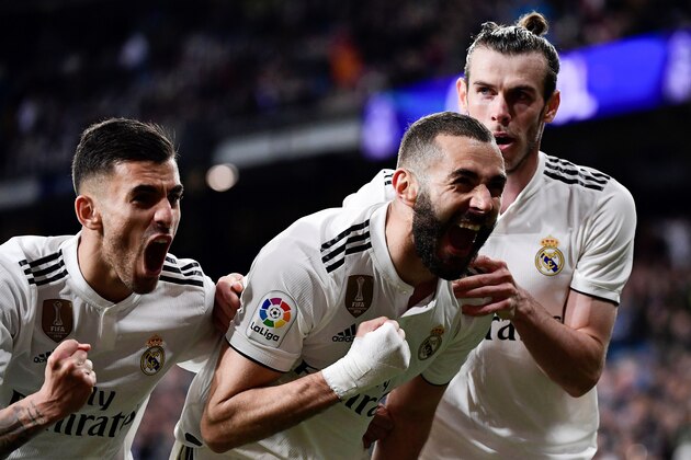 Real Madrid's French forward Karim Benzema celebrates with Real Madrid's Welsh forward Gareth Bale (R) and Real Madrid's Spanish midfielder Daniel Ceballos (L) after scoring his team's third goal during the Spanish League football match between Real Madrid CF and SD Huesca at the Santiago Bernabeu stadium in Madrid on March 31, 2019. (Photo by JAVIER SORIANO / AFP)        (Photo credit should read JAVIER SORIANO/AFP/Getty Images)