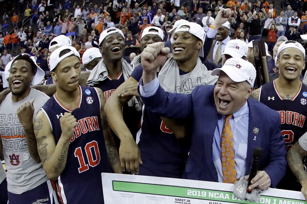 Auburn head coach Bruce Pearl celebrates with his team after the Midwest Regional final game against Kentucky in the NCAA men's College basketball tournament Sunday, March 31, 2019, in Kansas City, Mo. Auburn won 77-71 in overtime. (AP Photo/Charlie Riedel)