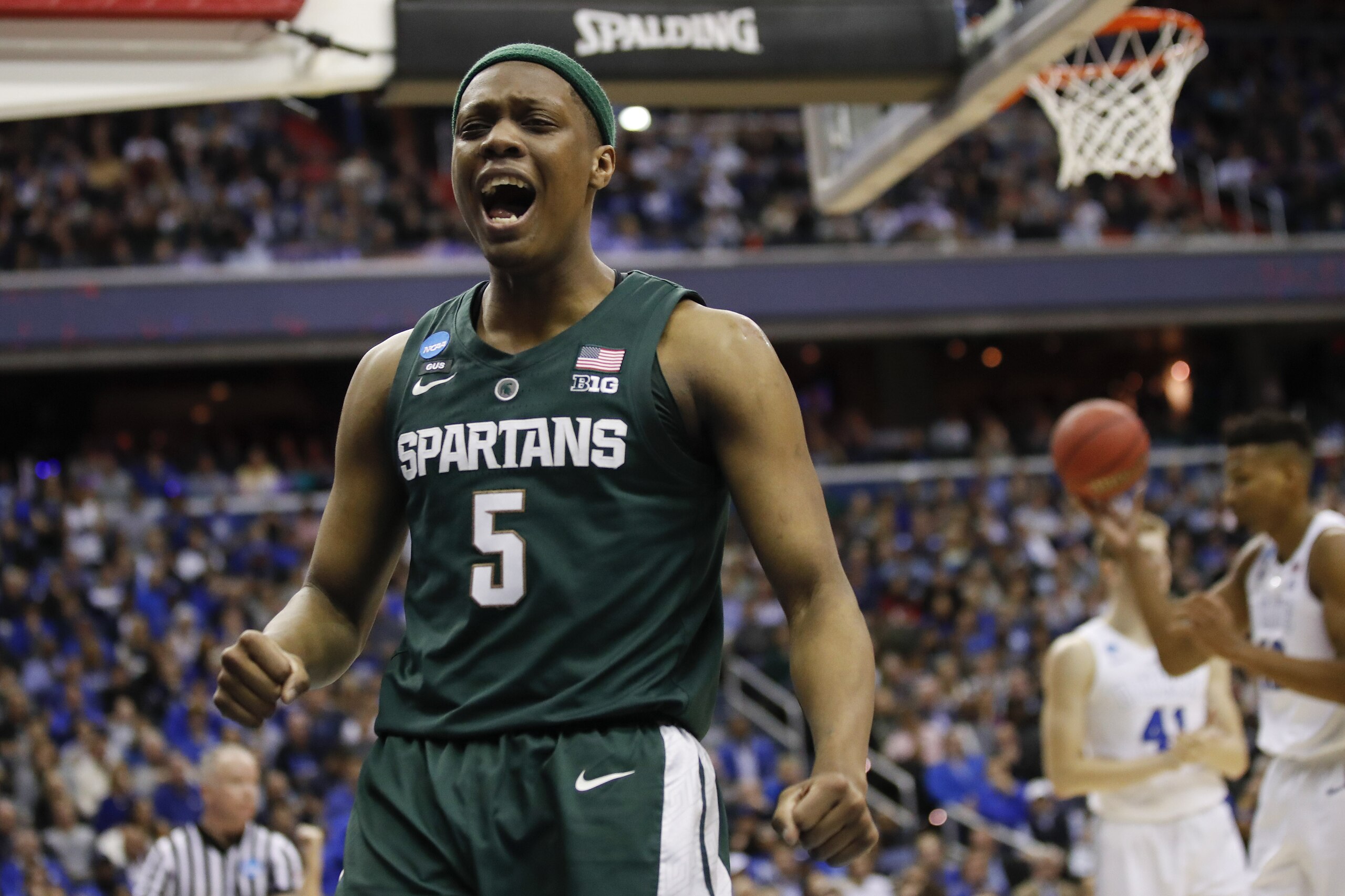 Michigan State guard Cassius Winston (5) reacts to scoring on Duke during the first half of an NCAA men's East Regional final college basketball game in Washington, Sunday, March 31, 2019. (AP Photo/Alex Brandon)