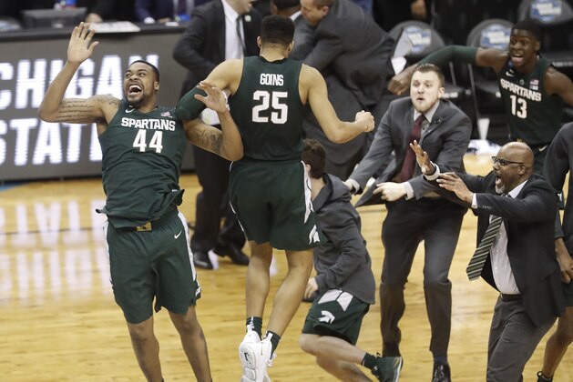 Michigan State forward Nick Ward (44) and Kenny Goins (25) celebrate with teammates after beating Duke at the end of the NCAA men's East Regional final collage basketball game in Washington, Sunday, March 31, 2019. Michigan State won 68-67. (AP Photo/Mark Tenally