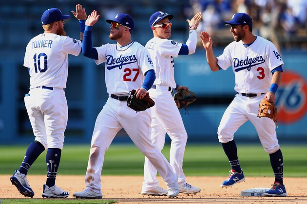 LOS ANGELES, CALIFORNIA - MARCH 31: Justin Turner #10, Alex Verdugo #27, Kike Hernandez #14 and Max Muncy #3 of the Los Angeles Dodgers celebrate their 8-7 victory against the Arizona Diamondbacks at Dodger Stadium on March 31, 2019 in Los Angeles, California. (Photo by Yong Teck Lim/Getty Images)