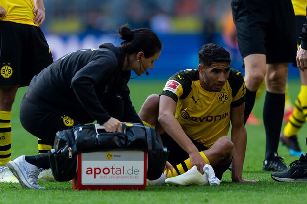DORTMUND, GERMANY - MARCH 30: Achraf Hakimi of Borussia Dortmund is injured during the Bundesliga match between Borussia Dortmund and VfL Wolfsburg at Signal Iduna Park on March 30, 2019 in Dortmund, Germany. (Photo by TF-Images/Getty Images)