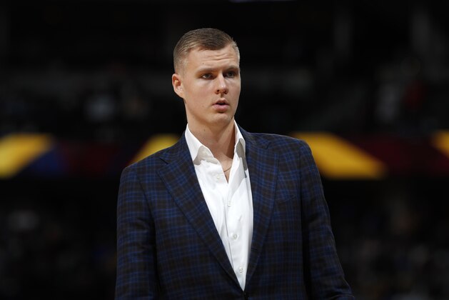 FILE - In this March 14, 2019, file photo, Dallas Mavericks forward Kristaps Porzingis stands during the second half of the team's NBA basketball game against the Denver Nuggets in Denver. An attorney for Porzingis acknowledges that a woman has accused the NBA star of rape, but “unequivocally” denies the allegation. Lawyer Roland Riopelle said Saturday, March 30, that the claim against the Dallas Maverick was part of an extortion attempt that is being investigated by the FBI. (AP Photo/David Zalubowski, File)