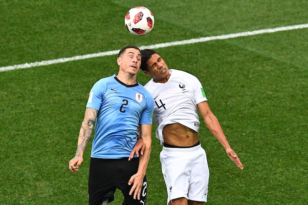 TOPSHOT - Uruguay's defender Jose Gimenez (L) vies for the header with France's defender Raphael Varane during the Russia 2018 World Cup quarter-final football match between Uruguay and France at the Nizhny Novgorod Stadium in Nizhny Novgorod on July 6, 2018. (Photo by Johannes EISELE / AFP)        (Photo credit should read JOHANNES EISELE/AFP/Getty Images)