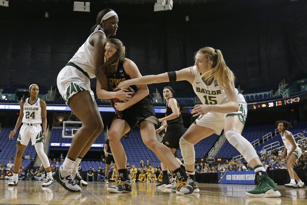 Iowa's Amanda Ollinger, center, is tied up by Baylor's Lauren Cox, right, and Kalani Brown, left, during the first half of a regional final women's college basketball game in the NCAA Tournament in Greensboro, N.C., Monday, April 1, 2019. (AP Photo/Chuck Burton)