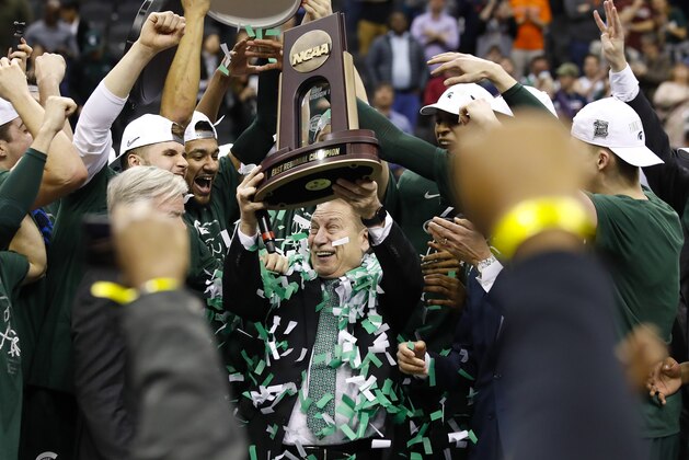 Michigan State head coach Tom Izzo holds up the NCAA men's East Regional Championship trophy after defeating Duke in a college basketball game in Washington, Sunday, March 31, 2019. Michigan State won 68-67. (AP Photo/Alex Brandon)