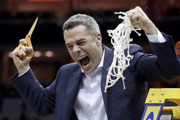 Virginia head coach Tony Bennett celebrates after defeating Purdue 80-75 in overtime of the men's NCAA Tournament college basketball South Regional final game, Saturday, March 30, 2019, in Louisville, Ky. (AP Photo/Michael Conroy)