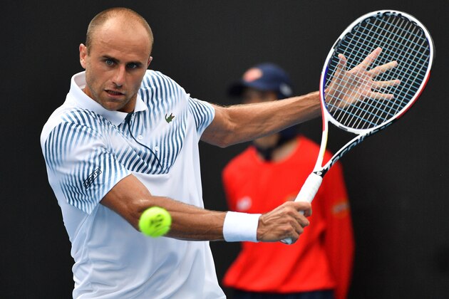 Romania's Marius Copil hits a return against Belgium's David Goffin during their men's singles match on day four of the Australian Open tennis tournament in Melbourne on January 17, 2019. (Photo by SAEED KHAN / AFP) / -- IMAGE RESTRICTED TO EDITORIAL USE - STRICTLY NO COMMERCIAL USE --        (Photo credit should read SAEED KHAN/AFP/Getty Images)
