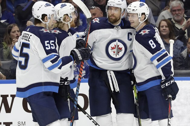 Winnipeg Jets right wing Blake Wheeler (26) celebrates his goal against the Tampa Bay Lightning with teammates, including center Mark Scheifele (55) and defenseman Jacob Trouba (8), during the first period of an NHL hockey game Tuesday, March 5, 2019, in Tampa, Fla. (AP Photo/Chris O'Meara)
