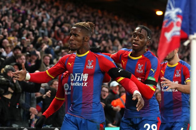 Crystal Palace's Ivorian striker Wilfried Zaha (L) celebrates with Crystal Palace's English midfielder Aaron Wan-Bissaka (R) after scoring their first goal during the English Premier League football match between Crystal Palace and West Ham United at Selhurst Park in south London on February 9, 2019. (Photo by Daniel LEAL-OLIVAS / AFP) / RESTRICTED TO EDITORIAL USE. No use with unauthorized audio, video, data, fixture lists, club/league logos or 'live' services. Online in-match use limited to 120 images. An additional 40 images may be used in extra time. No video emulation. Social media in-match use limited to 120 images. An additional 40 images may be used in extra time. No use in betting publications, games or single club/league/player publications. /         (Photo credit should read DANIEL LEAL-OLIVAS/AFP/Getty Images)