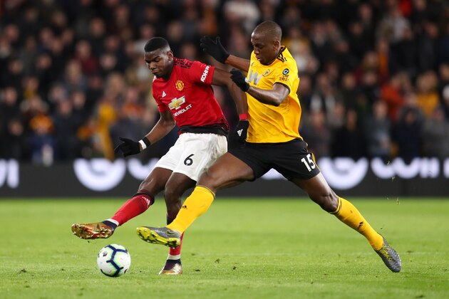 WOLVERHAMPTON, ENGLAND - APRIL 02:  Paul Pogba of Manchester United is challenged by Willy Boly of Wolverhampton Wanderers during the Premier League match between Wolverhampton Wanderers and Manchester United at Molineux on April 02, 2019 in Wolverhampton, United Kingdom. (Photo by Catherine Ivill/Getty Images)