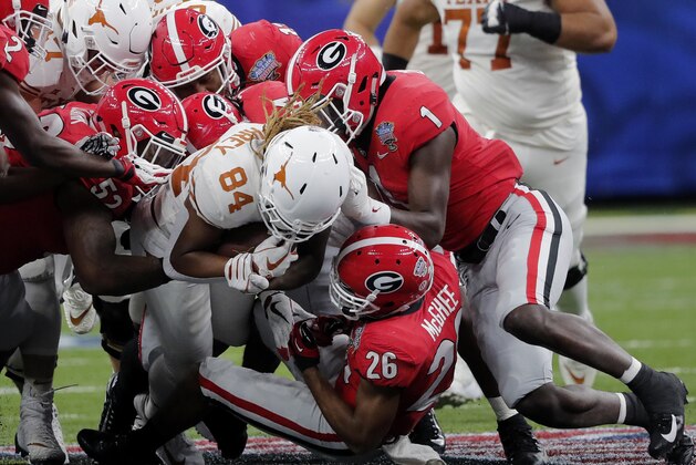 Texas wide receiver Lil'Jordan Humphrey (84) is stopped by Georgia defensive back Latavious Brini (36), linebacker Brenton Cox (1) and defensive lineman Tyler Clark (52) during the first half of the Sugar Bowl NCAA college football game in New Orleans, Tuesday, Jan. 1, 2019. (AP Photo/Gerald Herbert)