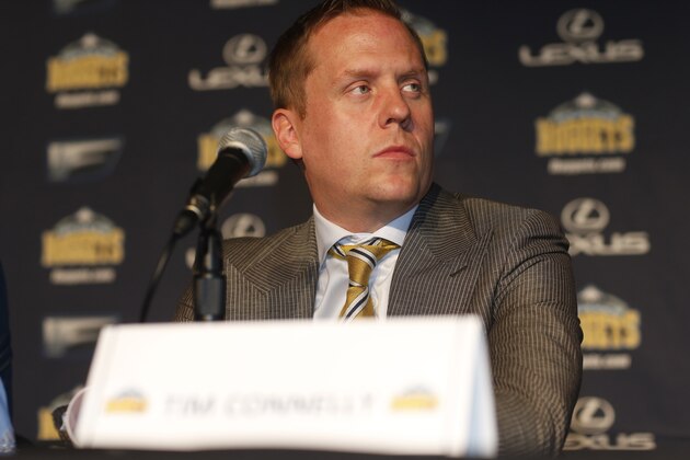 Denver Nuggets general manager Tim Connelly looks on as the team's first-round draft pick in the NBA draft, Emmanuel Mudiay, is introduced during an NBA basketball news conference Friday, June 26, 2015, in Denver. (AP Photo/David Zalubowski)