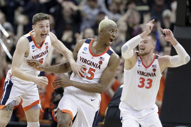 Virginia's Mamadi Diakite, center, reacts with teammates Kyle Guy and Jack Salt (33) after hitting a shot to send the game into overtime in the men's NCAA Tournament college basketball South Regional final game against Purdue, Saturday, March 30, 2019, in Louisville, Ky. (AP Photo/Michael Conroy)