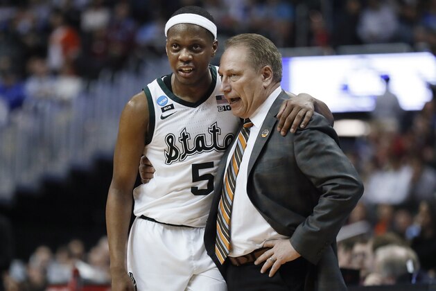 Michigan State guard Cassius Winston (5) puts his arm around coach Tom Izzo following the team's 80-63 win over LSU in an NCAA men's college basketball tournament East Region semifinal in Washington, Friday, March 29, 2019. (AP Photo/Patrick Semansky)