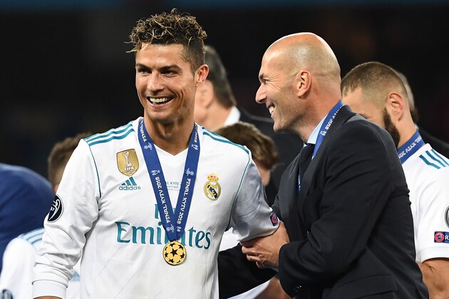TOPSHOT - Real Madrid's French coach Zinedine Zidane (R) celebrates with Real Madrid's Portuguese forward Cristiano Ronaldo after winning  the UEFA Champions League final football match between Liverpool and Real Madrid at the Olympic Stadium in Kiev, Ukraine, on May 26, 2018. (Photo by FRANCK FIFE / AFP)        (Photo credit should read FRANCK FIFE/AFP/Getty Images)