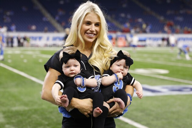 Kelly Stafford, wife of Detroit Lions quarterback Matthew Stafford holds the couple's twins Sawyer, left, and Chandler during pre-game of an NFL football game against the Atlanta Falcons, Sunday, Sept. 24, 2017, in Detroit. (AP Photo/Rick Osentoski)