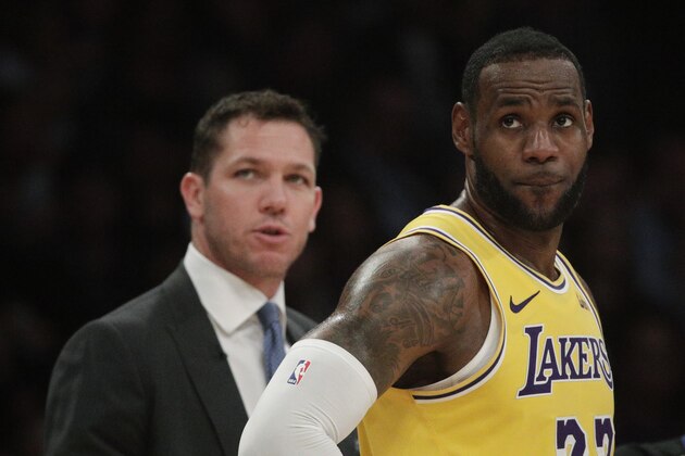 Los Angeles Lakers' LeBron James stands in front of head coach Luke Walton during the second half of an NBA basketball game against the Washington Wizards, Tuesday, March 26, 2019, in Los Angeles. The Lakers won 124-106. (AP Photo/Jae C. Hong)