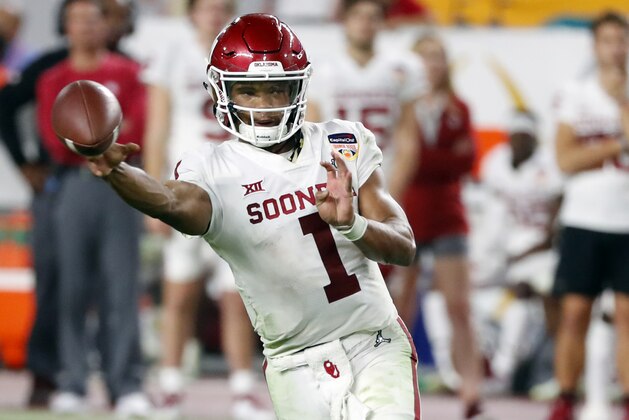 FILE - In this Dec. 29, 2018, file photo, Oklahoma quarterback Kyler Murray throws a pass during the second half of the Orange Bowl NCAA college football game against Alabama in Miami Gardens, Fla. The Oakland Athletics remain hopeful of seeing Heisman Trophy winner Murray in their baseball uniform when spring training begins next month. While the Oklahoma quarterback declared for the NFL draft last week, the prized outfielder could report to A’s spring training in Mesa, Arizona--and he has an invite to big league camp. (AP Photo/Wilfredo Lee, File)