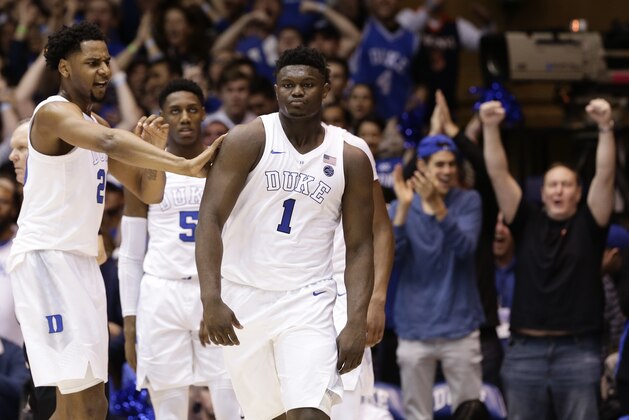 Duke's Marques Bolden, left, RJ Barrett and Zion Williamson (1) react following a basket against Virginia during the first half of an NCAA college basketball game in Durham, N.C., Saturday, Jan. 19, 2019. (AP Photo/Gerry Broome)