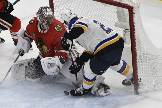 St. Louis Blues center Tyler Bozak, right, tries to score on Chicago Blackhawks goaltender Cam Ward, left, during the third period in an NHL hockey game Wednesday, April 3, 2019, in Chicago. The Blackhawks won 4-3 in a shootout. (AP Photo/David Banks)