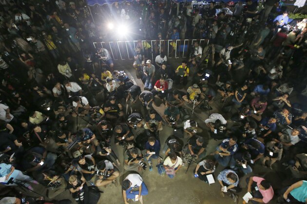 Thai media listen Chiang Rai province acting Gov. Narongsak Osatanakorn, who is leading the ongoing rescue operation of the soccer team and coach trapped in a flooded cave, during a press conference in Mae Sai, Chiang Rai province, northern Thailand, Tuesday, July 10, 2018.Thai Navy SEALs say all 12 boys and their coach were rescued from the cave, ending an ordeal that lasted more than 2 weeks. (AP Photo/Sakchai Lalit)